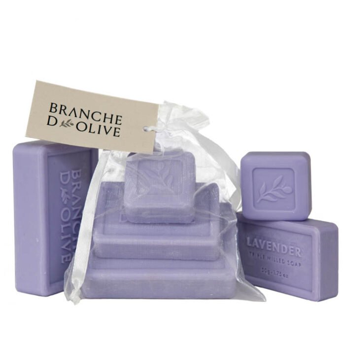 Branche d'Olive Lavender Mauve Soap Steps, three sizes of soap stepped on each other bagged and tagged with display Lavender Mauve Soap as a backdrop