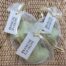 Three Branche d'Olive bagged and tagged Garrigue large heart shaped soaps lying on Hexcel wrapping