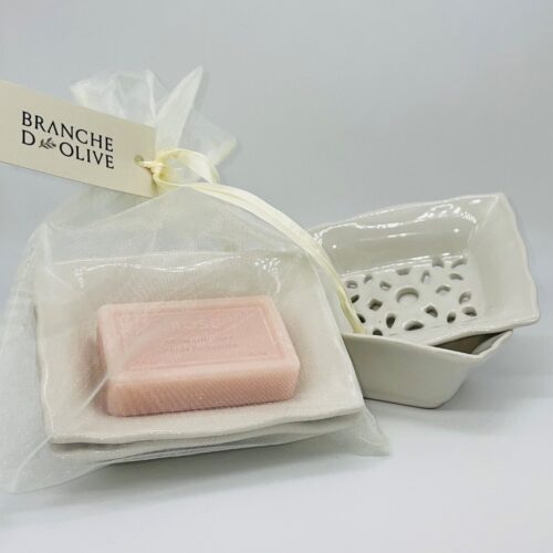 Branche d'Olive's signature double layered medium draining soap dish shown bagged& tagged with Old Rose soap beside an unbagged version against a pale background