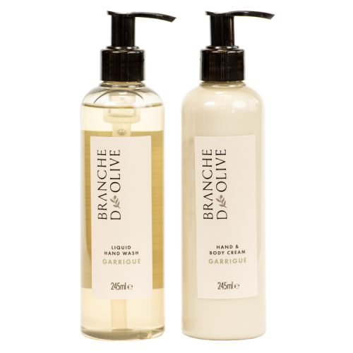 Two products from Branche d'Olive's hand and body care ranges. Two pumped bottles, labelled luxury hand wash and luxury hand/body lotion set against a white backdrop