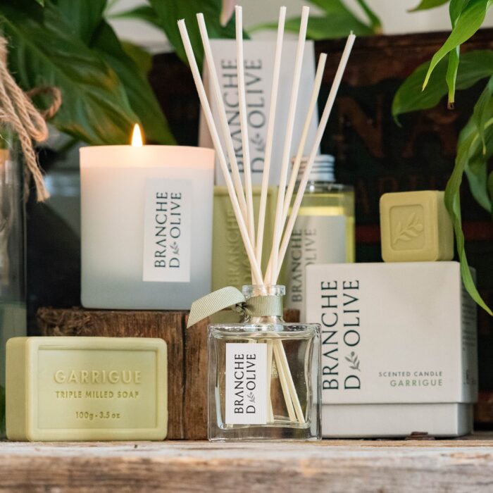 The Branche d'Olive Garrigue Diffuser surrounded by the Garrigue Soap, Scented Candle and Refill