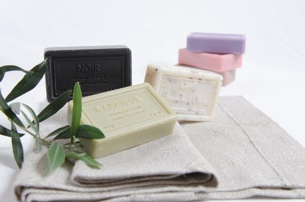 Branche d'Olive bruised soaps shown on Branche d'Olive hand towel with small olive twig.