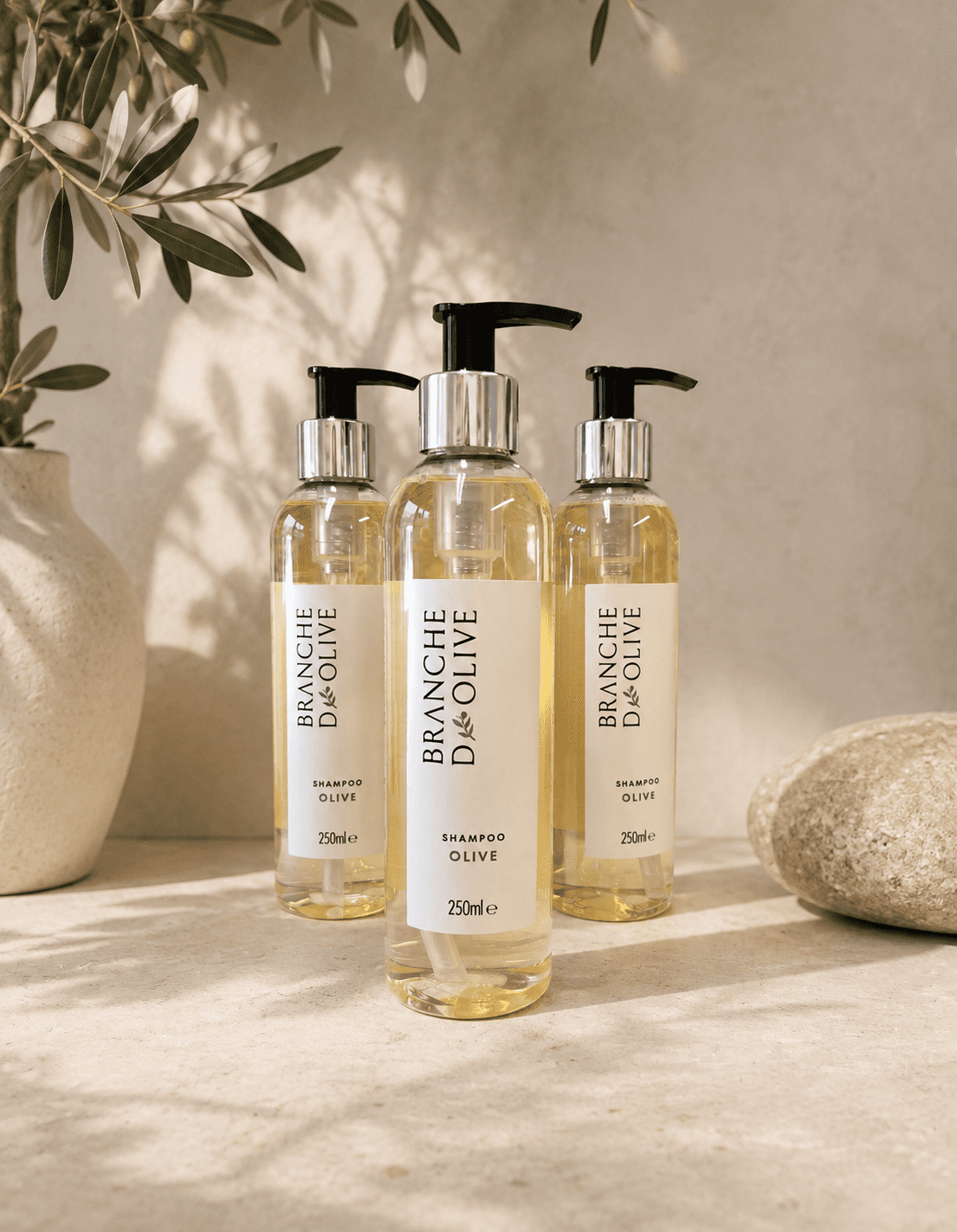 Branche d'Olive Shampoo with chrome pumps pictured beside Olive branches